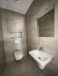 Gäste-WC - Stilvolle KfW 40 EE Neubau OG-Wohnung Nr. 5 im Zentrum von Ostrhauderfehn! mit Stellplatz und Balkon